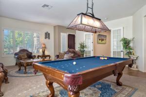 a living room with a pool table in it at Modern Paradise: King Bed + EV Charger +Pool Table in Goodyear
