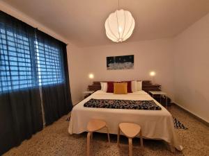 a bedroom with a large bed and a chandelier at JB23 apts 3 bedroom apartment near Airport in San Juan
