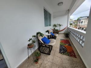 a balcony with chairs and tables on a building at JB23 apts 3 bedroom apartment near Airport in San Juan