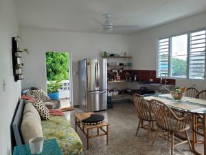 a kitchen and living room with a couch and a table at JB23 apts 3 bedroom apartment near Airport in San Juan