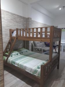 a wooden bunk bed in a room at Monoambientes in Villa Alsina