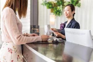 two women sitting at a desk with a laptop at Hotel JAL City Haneda Tokyo in Tokyo