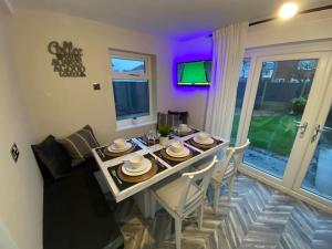 a dining room with a table and a couch at Wharfedale Lodge- Bungalow-3 Bed, 2 bath, Amazing! in Thornton