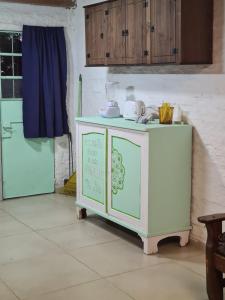 un armario en una cocina con una mesa con platos. en Nuestro rincón en San grgorio, a media cuadra de la playa, en San Gregorio de Polanco
