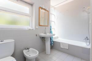 a bathroom with a toilet and a sink and a bath tub at Luxury villa in front of the sea ROSITA in Calella de Palafrugell +21 photos