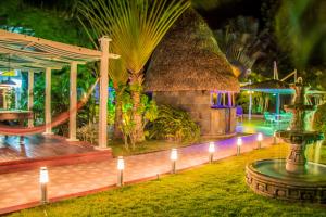 a resort with lights in the yard at night at HOTEL CASA AMARILLA et RESTAURANT in Punta Chame