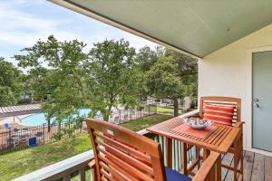 a table and chairs on a balcony with a view at Fulton Beach Condos in Rockport