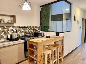 a kitchen with a counter with a stove and a table at Sucre Center II in Sucre