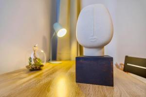 a white sculpture on a table in a room at 4-Room Luxury Apartment - close to Central Station, free parking, kitchen in Leipzig