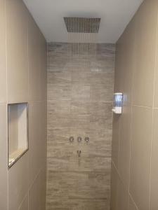 a bathroom with a shower with a tile floor at Aires del Sur in Dina Huapi