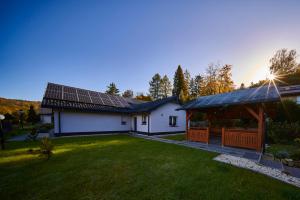 a house with solar panels on the roof at Pensjonat Na Każdą Porę in Lądek-Zdrój