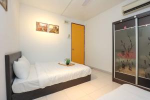a bedroom with a bed and a orange door at Cyberjaya Cyberia landed house BBQ By EC in Cyberjaya +25 photos
