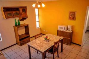 華雷斯城的住宿－Departamento con Amplia Terraza en Excelente Zona，厨房配有桌椅和微波炉。