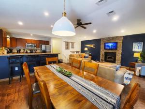 a dining room and living room with a wooden table at Firepit, BBQ, AC, Indoor Pool, KING bed, Self check in, Indoor Fireplace, FREE Amenities in Lake Ariel