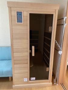 a wooden cabinet with a glass door in a room at pier21 in Hakodate