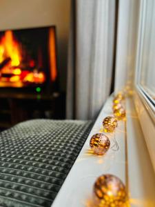 a room with christmas balls on a bed with a fireplace at Bella's Place in Breda