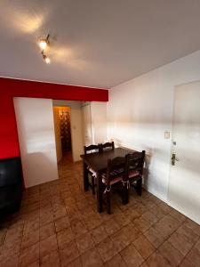 a dining room with a table and two benches at Apartamento Punta del Este in Punta del Este