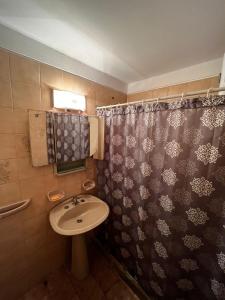 a bathroom with a sink and a shower curtain at Apartamento Punta del Este in Punta del Este