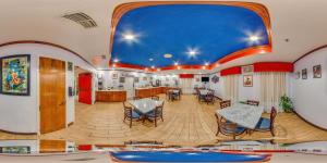 a room with tables and chairs and a blue ceiling at Hometown Inn Thomasville in Thomasville
