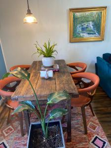 a wooden table with a potted plant on it at Boho-Chic Travel Pad - Unit 2 in Bloomington