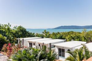 a view of a house with the ocean in the background at Freedom Shores Resort Airlie Beach in Airlie Beach