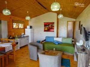 a kitchen and a living room with a bed in a room at Un Sueño 2 in Punta Del Diablo