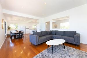 a living room with a couch and a table at Marine Drive in Forster