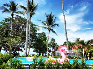 a pink flamingo pool at a resort with palm trees at Lanta Beach Resort in Ko Lanta