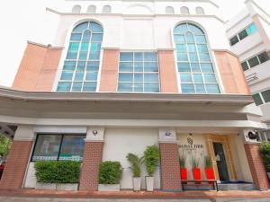 a building with plants in pots in front of it at Sabai Dee Minitel in Dusit