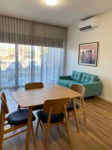 a living room with a table and chairs and a couch at Whittlesea Motel 