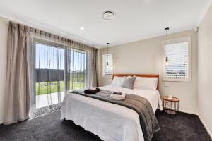 a bedroom with a large bed and a large window at 39Carmine Five Star 4-bedroom Holiday Home in Appleby