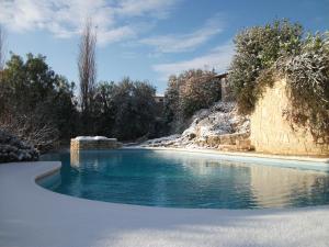 a swimming pool with snow on the ground at Maglioferro Residence in Corato