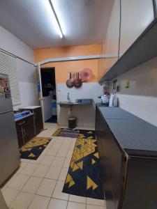 a kitchen with a counter and a tile floor at Dhuha Homestay @ Seri Alam Masai , Johor in Masai