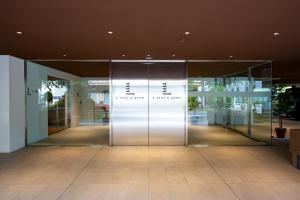 an entrance to a building with a revolving door at L stay＆grow晴海 in Tokyo