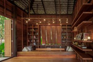 a library with bookshelves and a door in a room at The Spa Resorts - Lamai Village in Amphoe Koksamui