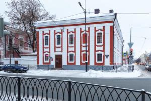 a red and white building on the side of a street at Hostel Saracen on Bolshaya Krasnaya in Kazan
