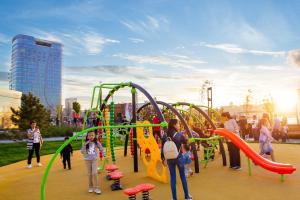 a group of children playing on an outdoor playground at Covent Garden in Tashkent