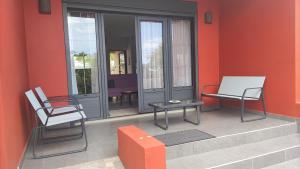 een patio met 2 stoelen en een tafel en stoelen bij Mon oasis in Saint-Louis