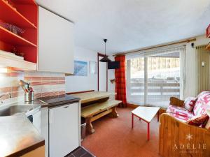 een keuken en woonkamer met een bank en een tafel bij Appartement 2P à 80m des Pistes et Commerces, Balcon, Casier à Skis. - FR-1-398-569 in La Rosière