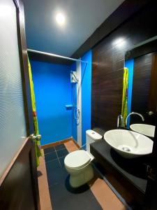 a bathroom with a white toilet and a sink at Phi Phi Sea Sky Resort in Phi Phi Islands