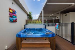 a jacuzzi tub sitting on top of a balcony at Aura 10 Shoal Bay in Shoal Bay