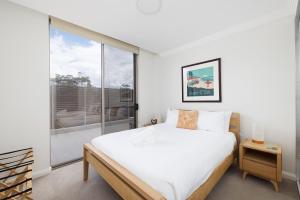 a bedroom with a bed and a large window at Aura 10 Shoal Bay in Shoal Bay +9 photos