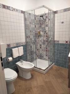a bathroom with a shower and a toilet and a sink at THE BEST SUITES & ROOMS - A pochi passi dalla kasbah - in Mazara del Vallo