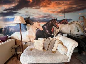 a room with a painting of horses on the wall at Ideal for country holidays and trips to London's tourist attractions in Hemel Hempstead