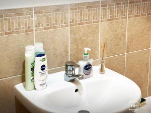 a bathroom sink with two bottles ofodorizers on it at Ideal for country holidays and trips to London's tourist attractions in Hemel Hempstead
