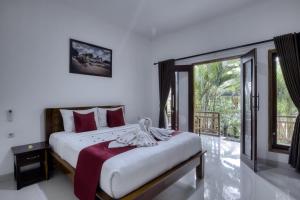 1 dormitorio con cama grande y ventana grande en Indah Guest House Nusa Penida en Nusa Penida