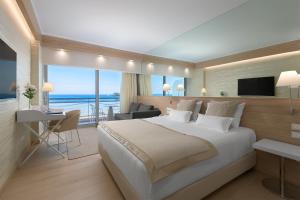 A bed or beds in a room at Mediterranean Hotel