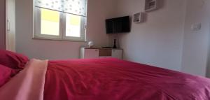 a bedroom with a pink bed with a window at Apartment Heaven Hill in Jadranovo +31 photos