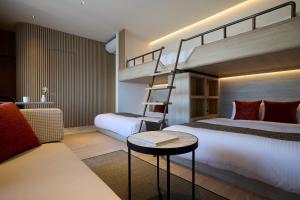 a bedroom with two beds and a bunk bed at FAV HOTEL Hiroshima Heiwa Odori in Hiroshima