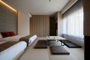 Cama ou camas em um quarto em fav HIROSHIMA HEIWAODORI